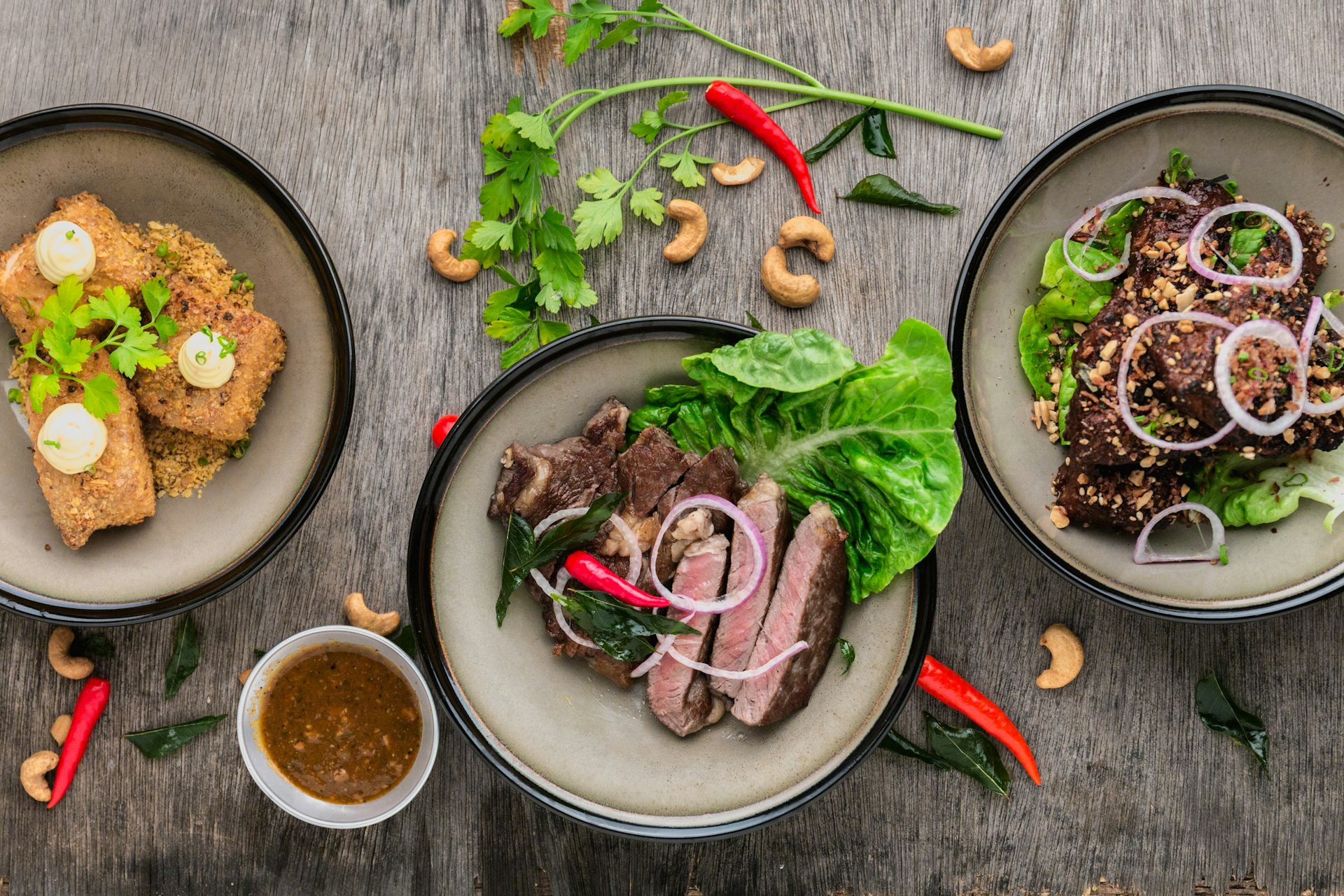 Diverse spread of delicious foods including healthy salads, comfort foods, and fresh sushi arranged on an elegant marble table - perfect meal inspiration